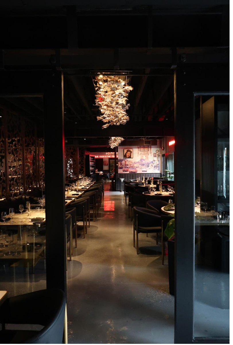 View through the doorway to the chandelier and main dining room at Blackbrick
